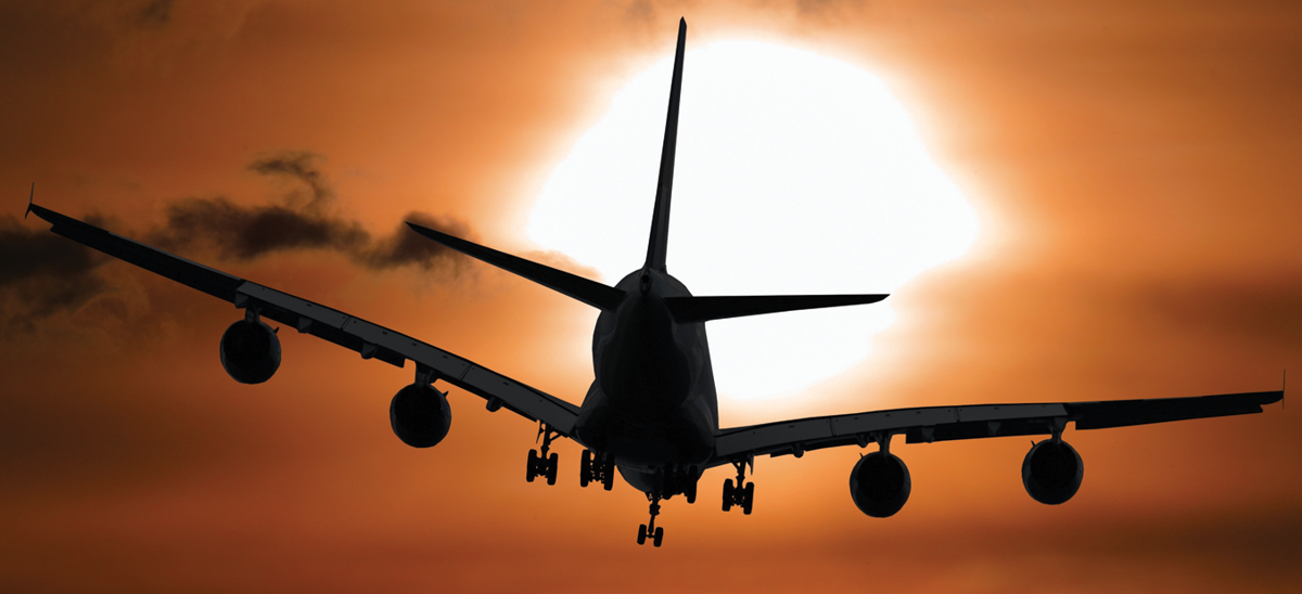 airplane-flying-sunset.png
